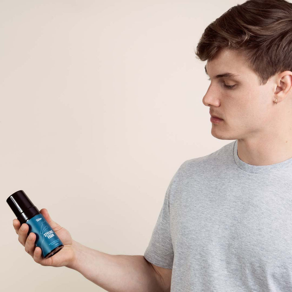 Men holding a hair styling product
